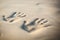 Couple of lovers at a beautiful sunset over the ocean. Couple on a romantic vacation. Imprint pair of hands in the sand, wedding r