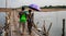 couple of lovers crossing old traditional bamboo wooden bridge across Mekong river