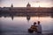 Couple, lovers, looking at a smarthone on the riverbank of the rhone, on the Quais De Rhone, facing Hotel Dieu