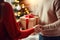 Couple lovingly giving each other gifts on Christmas Eve close up