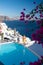 Couple at luxury infinity pool, antorini Greece, young couple on luxury vacation at the Island of Santorini watching