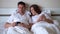Couple are lying in bed and watching smartphone