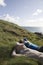 Couple Lying On Coastal Landscape