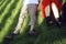 Couple lying and relaxing on the grass. Legs, top view. two pair of male and female legs in shoes lying on green grass.