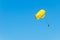 A couple makes parasailing on a sunny day. Parachuting above the clouds. Parasailing in a blue sky. Parachute walk on the sea