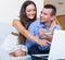 Couple making list for shopping online