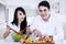 Couple making vegetables salad