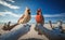 A couple of male and female Northern cardinal perched on driftwood, blurred blue sky background generative AI