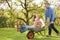 Couple With Man Giving Woman Ride In Wheelbarrow