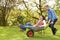 Couple With Man Giving Woman Ride In Wheelbarrow