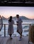 couple man and woman drinking coffee during on balcony sunrise at vacation in Cape Town South Africa