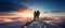 Couple of man and woman hikers on top of a mountain in winter at sunset or sunrise, together enjoying their climbing success