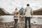 Couple man and woman holding hands enjoying mountains and lake view