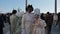 Couple of man and woman masked in full white costume at the Venice Carnival