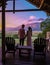 couple man and woman mid age in front of their lodge during vacation in South Africa, Mountains and grassland near