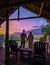 couple man and woman mid age in front of their lodge during vacation in South Africa, Mountains and grassland near