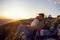 Couple Man and Woman sitting on cliff enjoying mountains and clouds landscape Love and Travel happy emotions Lifestyle