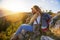 Couple Man and Woman sitting on cliff enjoying mountains and clouds landscape Love and Travel happy emotions Lifestyle