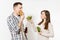 Couple man and woman standing with green detox smoothies, salad in glass bowl, burger, cola in glass bottle isolated on