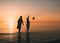 Couple of man and woman standing in the sea and throw your shoes at the beach.