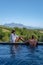 couple man and woman in swimming pool looking out over the Vineyards and mountains of Stellenbosch South Africa