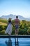 couple man and woman in swimming pool looking out over the Vineyards and mountains of Stellenbosch South Africa