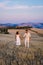 couple man and woman on vacation in Italy Toscane watching the golden hills of Toscane in Italy Europe,Tuscany landscape