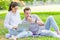 Couple man and women teen working use laptop to working at outdoor park holiday