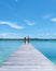 couple man and women on wooden board walk of a tropical Island in Thailand, Koh Kham near Koh Mak