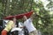 Couple With Map On Car Bonnet In Forest