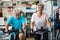 Couple of mature people or active seniors doing exercise in the gym riding the bicycle indoor to be healthy - two happy retired