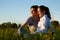 Couple on meadow in sunset