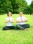 Couple Meditating In Park