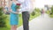 Couple meeting on a date, young man giving red rose to his beautiful girlfriend