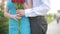 Couple meeting on a date, young man giving red rose to his beautiful girlfriend