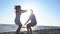 Couple meets on the beach and jump into each other`s arms