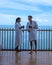 couple men and woman having a coffee on the balcony looking out over the bay of Pattaya, Thai girl and European man on