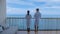 couple men and woman having a coffee on the balcony looking out over the bay of Pattaya, Thai girl and European man on