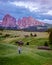 Couple men and woman on vacation in the Dolomites Italy,Alpe di Siusi - Seiser Alm with Sassolungo - Langkofel mountain