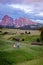 Couple men and woman on vacation in the Dolomites Italy,Alpe di Siusi - Seiser Alm with Sassolungo - Langkofel mountain