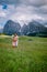 Couple men and woman on vacation in the Dolomites Italy,Alpe di Siusi - Seiser Alm with Sassolungo - Langkofel mountain