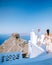 Couple men and woman on vacation Santorini, View to the sea and Volcano from Fira the capital of Santorini island in
