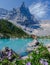 Couple of men and women visiting Lago di Sorapis in the Italian Dolomites,blue lake Lago di Sorapis, Lake Sorapis