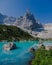 Couple of men and women visiting Lago di Sorapis in the Italian Dolomites,blue lake Lago di Sorapis, Lake Sorapis