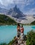 Couple of men and women visiting Lago di Sorapis in the Italian Dolomites,blue lake Lago di Sorapis, Lake Sorapis