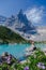 Couple of men and women visiting Lago di Sorapis in the Italian Dolomites,blue lake Lago di Sorapis, Lake Sorapis