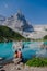 Couple of men and women visiting Lago di Sorapis in the Italian Dolomites,blue lake Lago di Sorapis, Lake Sorapis