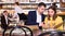 Couple with menu is choosing order in time dinner