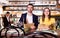 Couple with menu is choosing order in time dinner