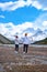 couple mid age men and woman hiking in the Canadian Rockies near Alberta Banff national park with snowy mountains